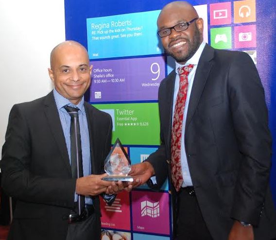 Kunle Awosika From Microsoft Kenya Presents Partner Award to Hasmukh Chudasama From Dimension Data East Africa JUUCHINI